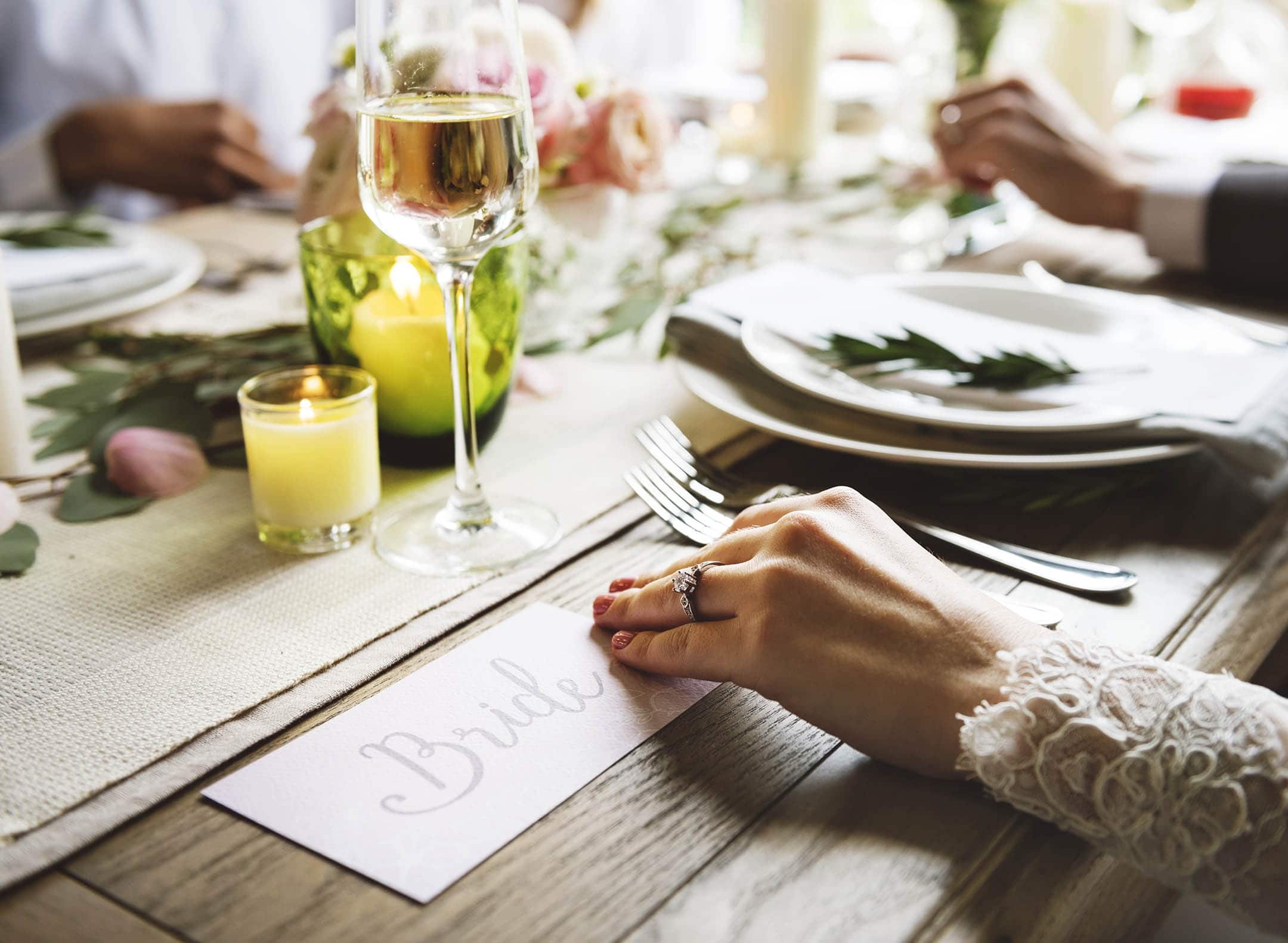 Close up of Bride sat at table of the wedding breakfast. Awaiting meal.